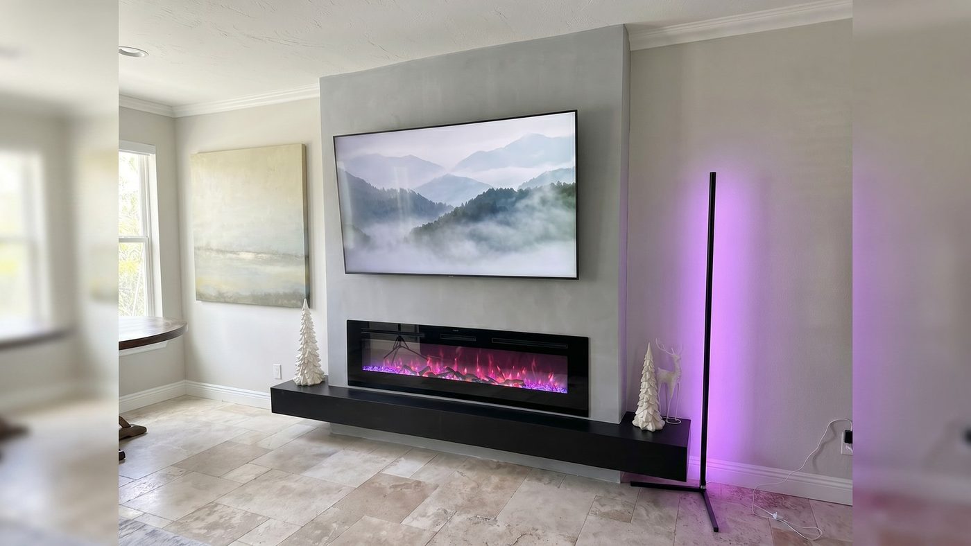 Minimalist panel media wall with a mounted TV and linear fireplace